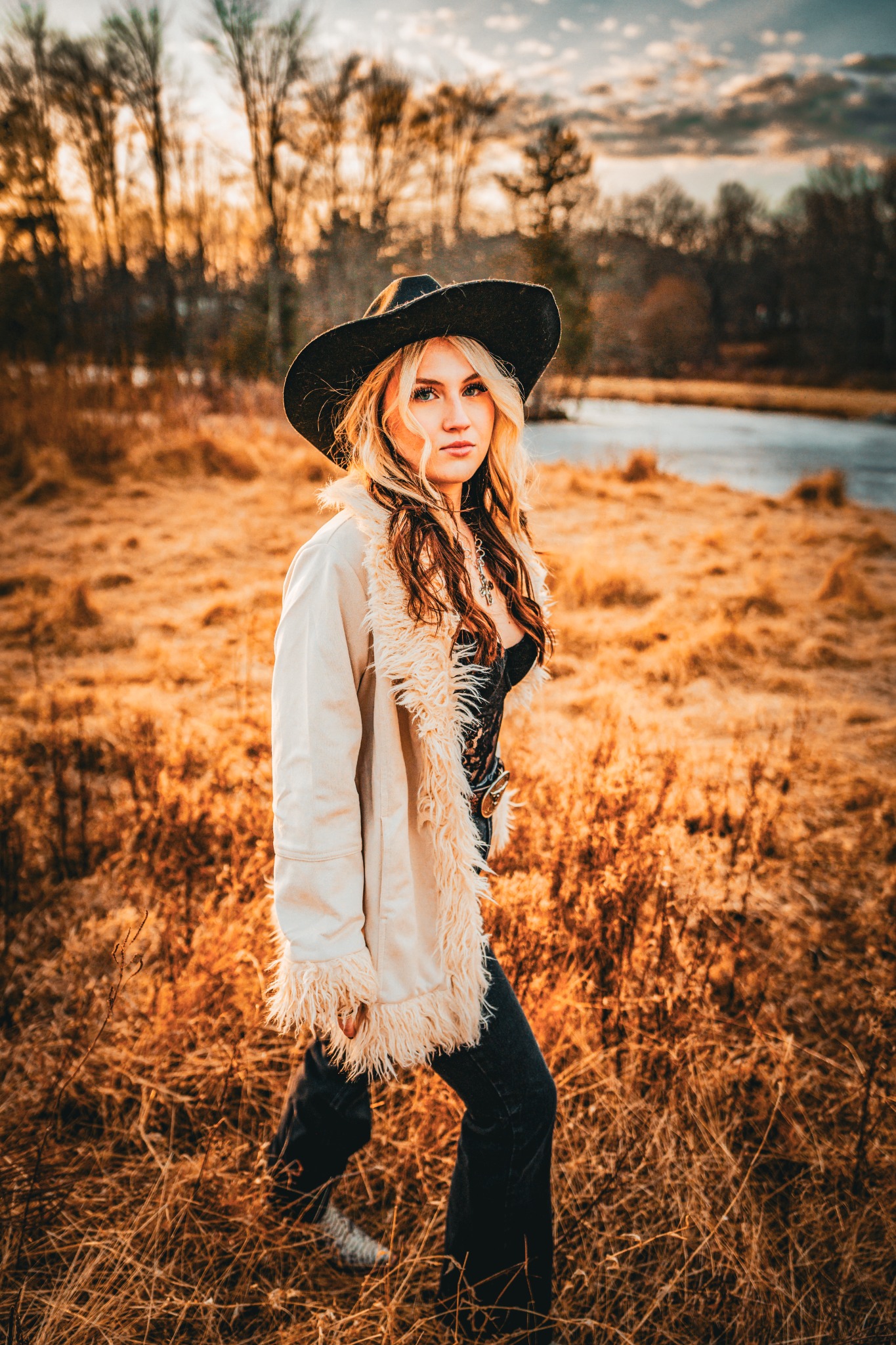 Lilly Moss outdoors near a lake in her official press photos